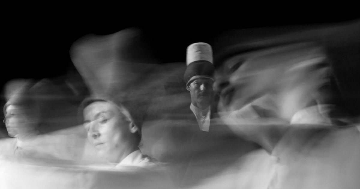 Dynamic dance captured in artistic black and white with blurred motion.