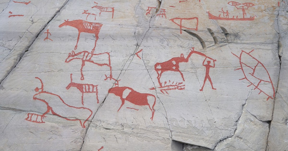 Ancient carvings on rocks depicting animals and humans at Alta, Norway.