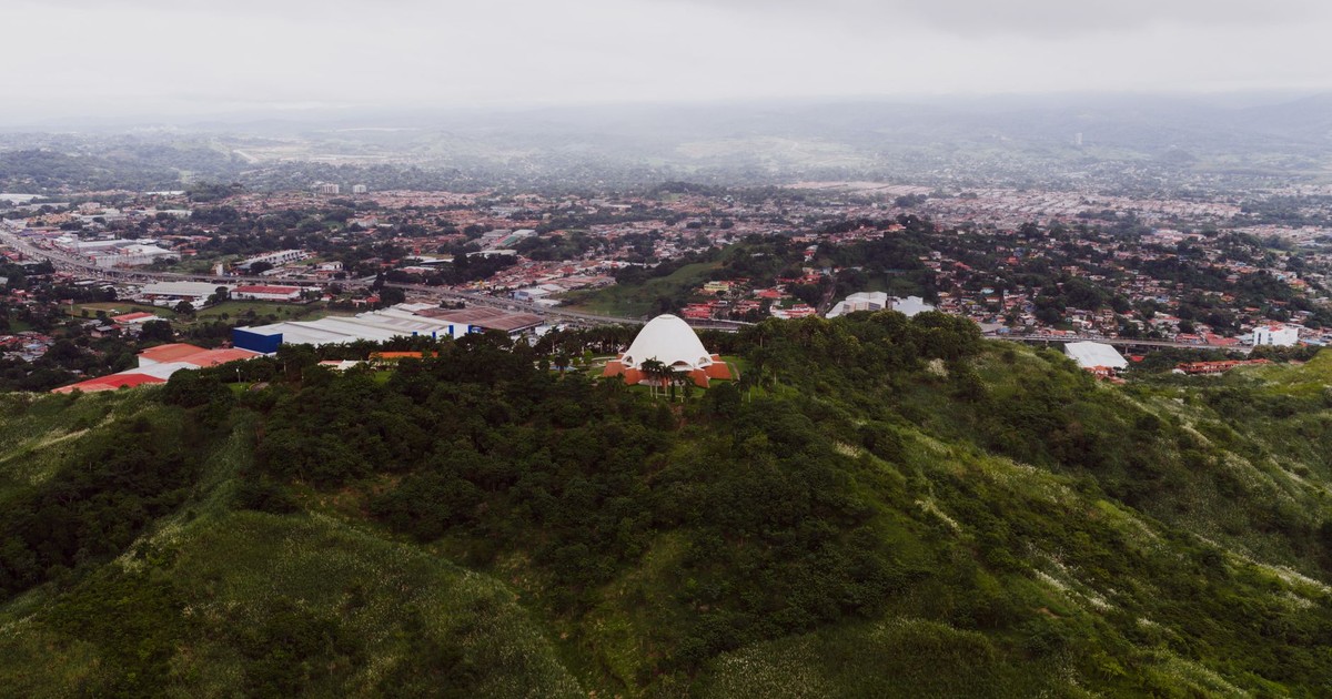 A stunning aerial view of Panama City with lush green hills and urban landscape.